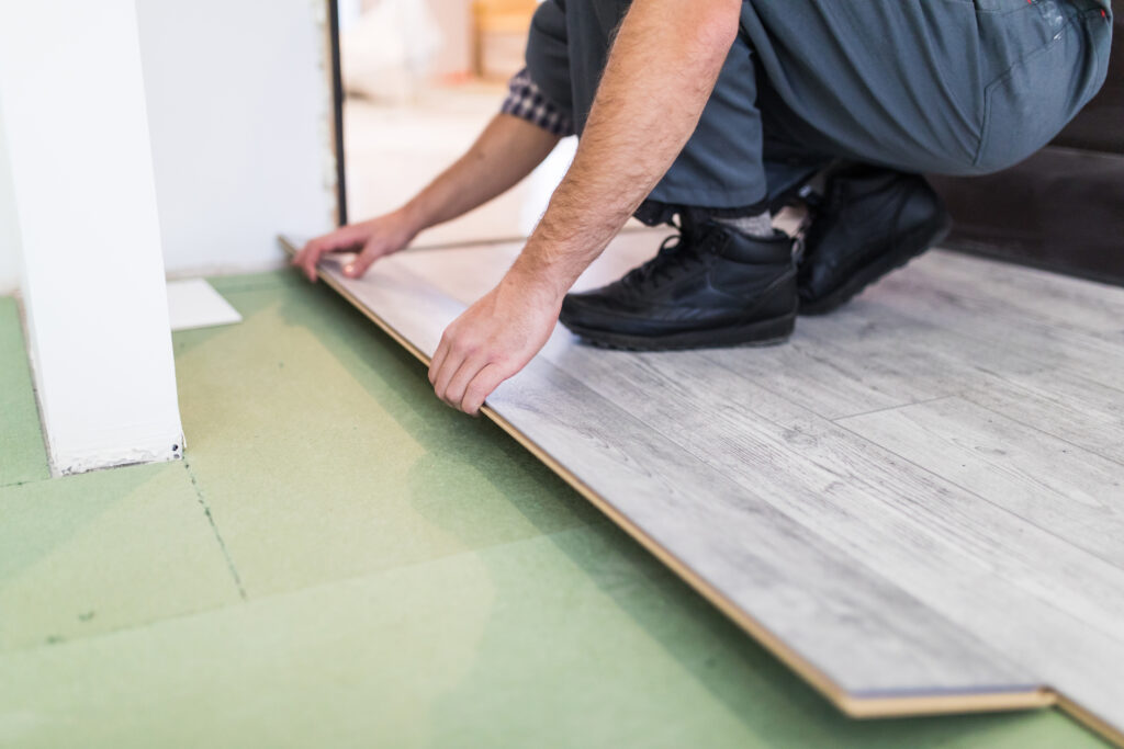 worker installing floor tiles